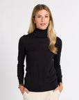 Woman modeling a black tissue turtleneck on a white background