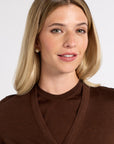 Close up of a woman wearing a tissue cardigan in a studio