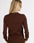 Woman modeling a brown cashmere cardigan in a studio