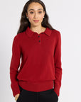 Woman modeling a red cashmere polo in a studio