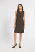 A woman modeling a sleeveless knee-length dress with a textured black and gold tweed pattern, paired with black pointed-toe heels and gold jewelry, against a plain white studio background.