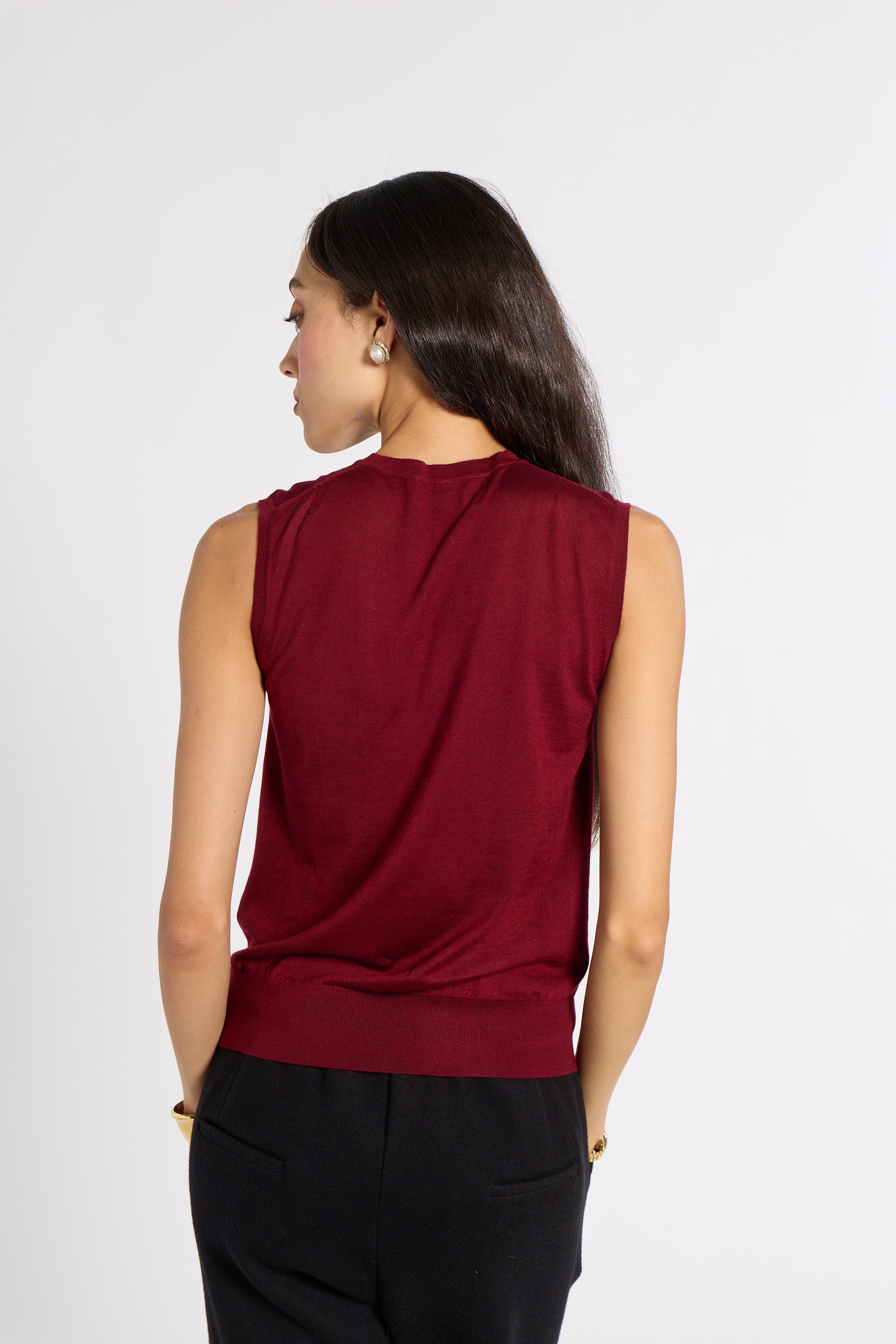 Woman standing with her back to the camera wearing a red tissue shell
