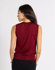 Woman standing with her back to the camera wearing a red tissue shell