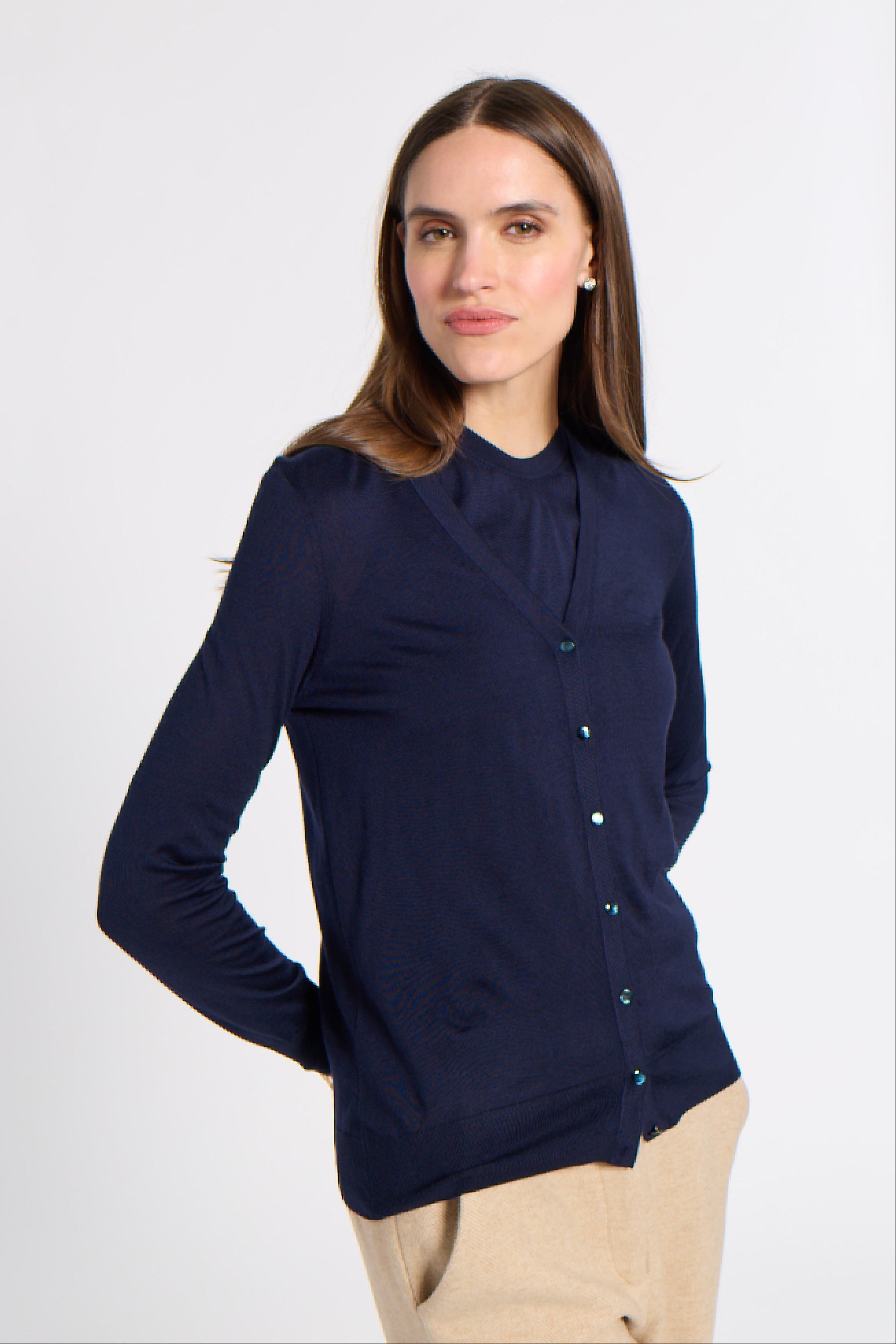 Woman in a navy blue cardigan in a studio