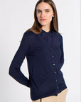 Woman in a navy blue cardigan in a studio