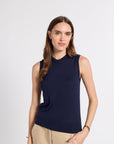 Woman in navy tissue shell on a white background