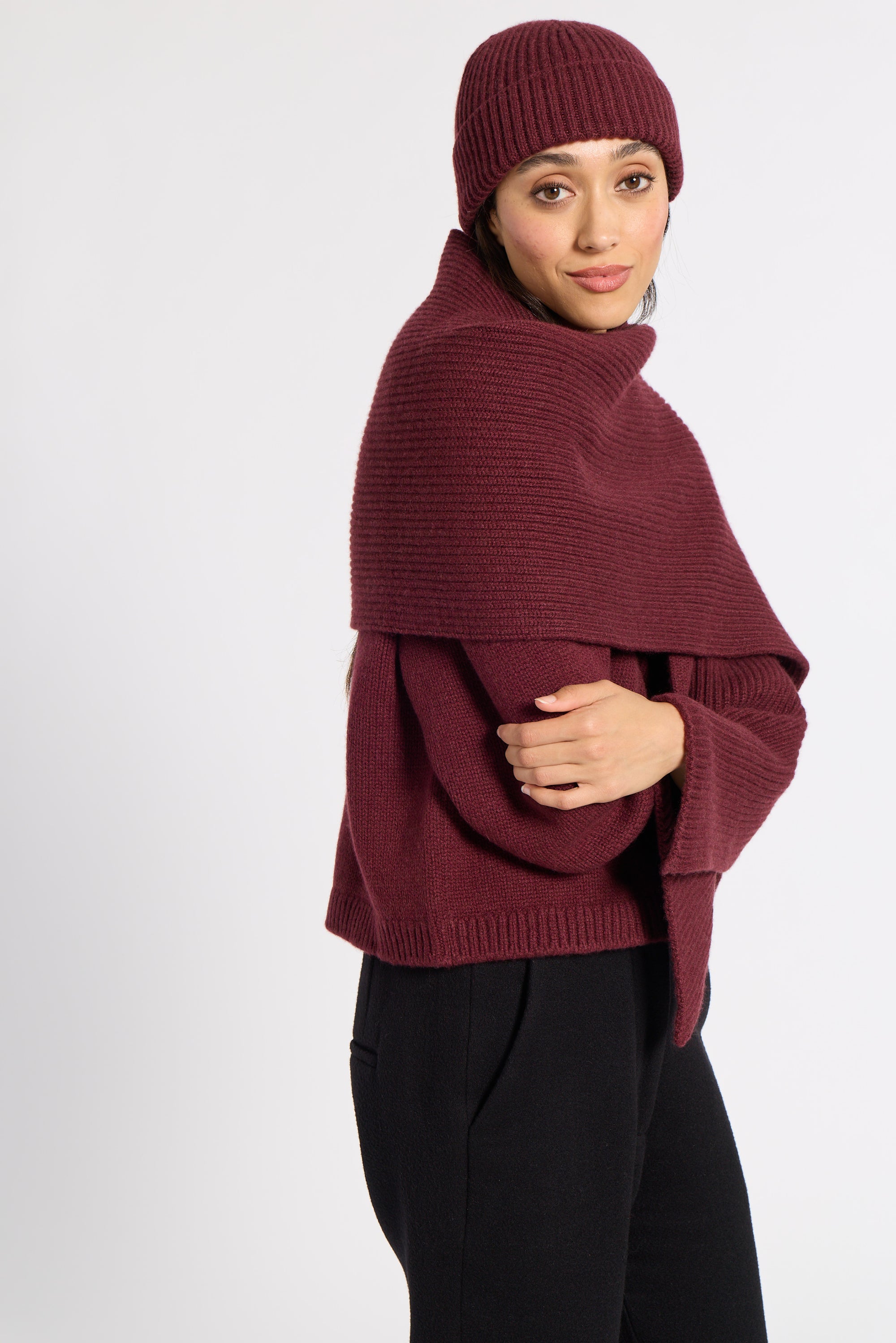 Woman wrapped in a burgundy cashmere scarf and beanie