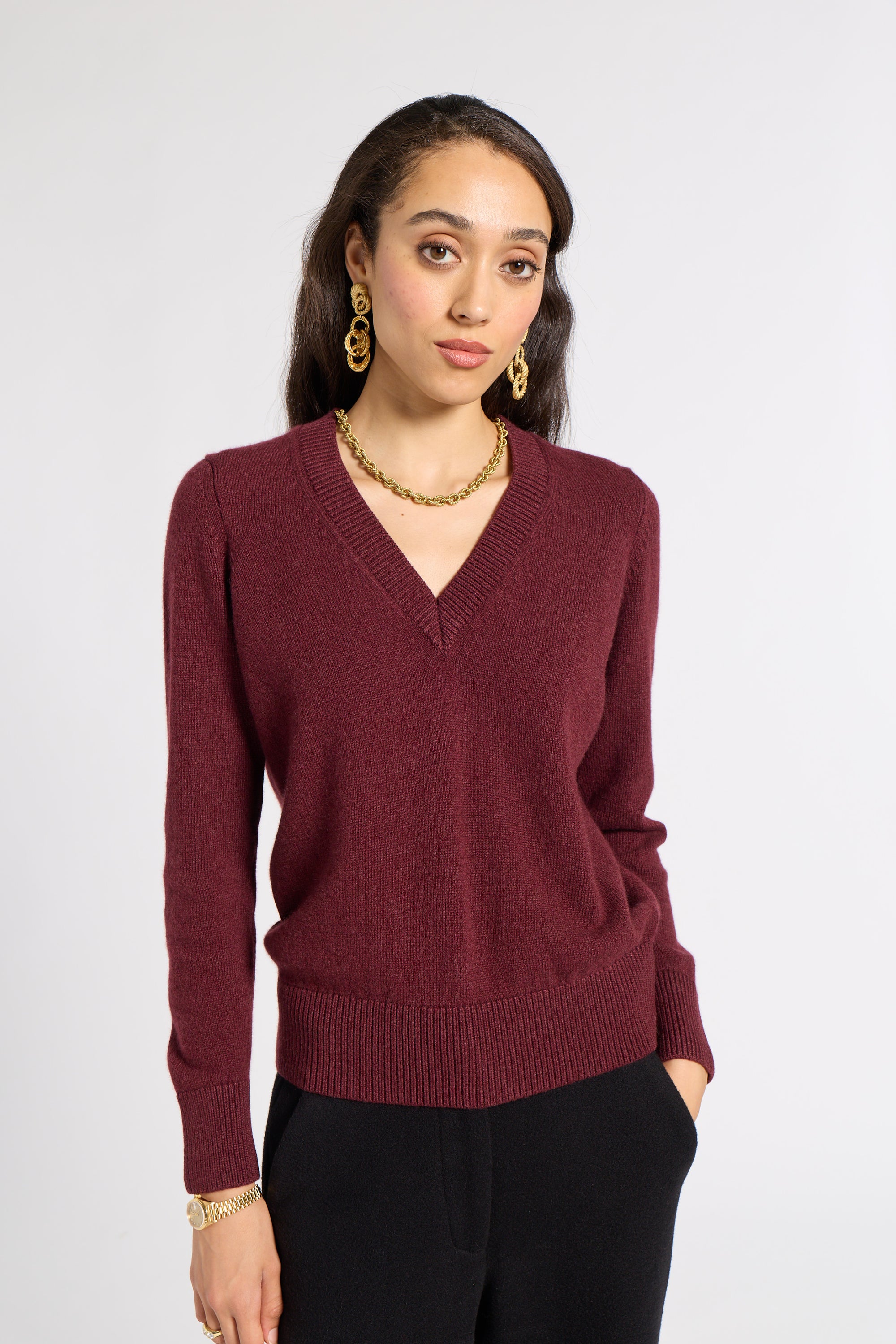 Burgundy v neck sweater on a white background
