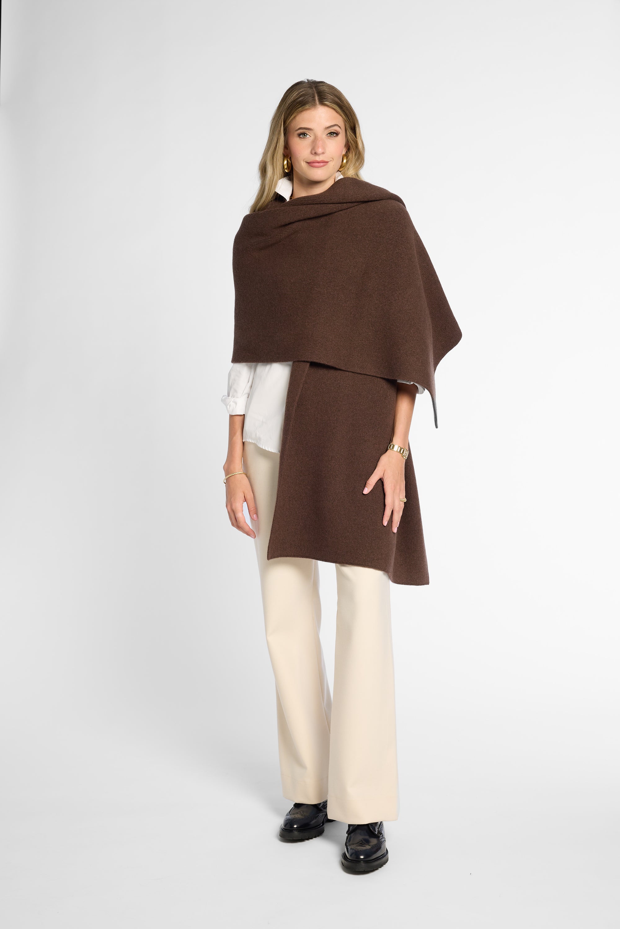 Another Front View: Woman wearing a chocolate brown wrap on top of a white button up shirt and khakis in front of a white background.