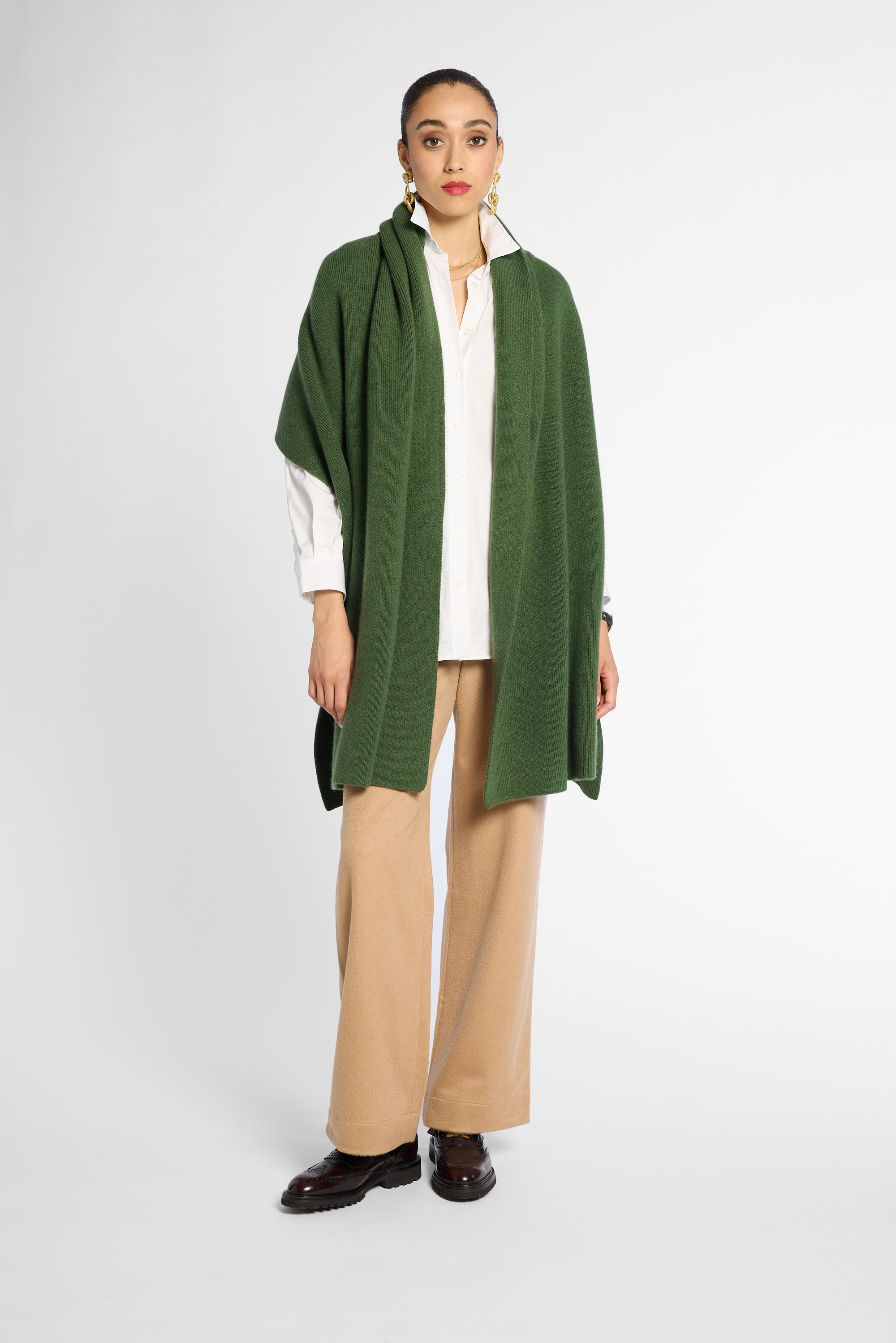 Front view of women wearing a Forest Green cashmere wrap over a white shirt and tan pants in front of a white background