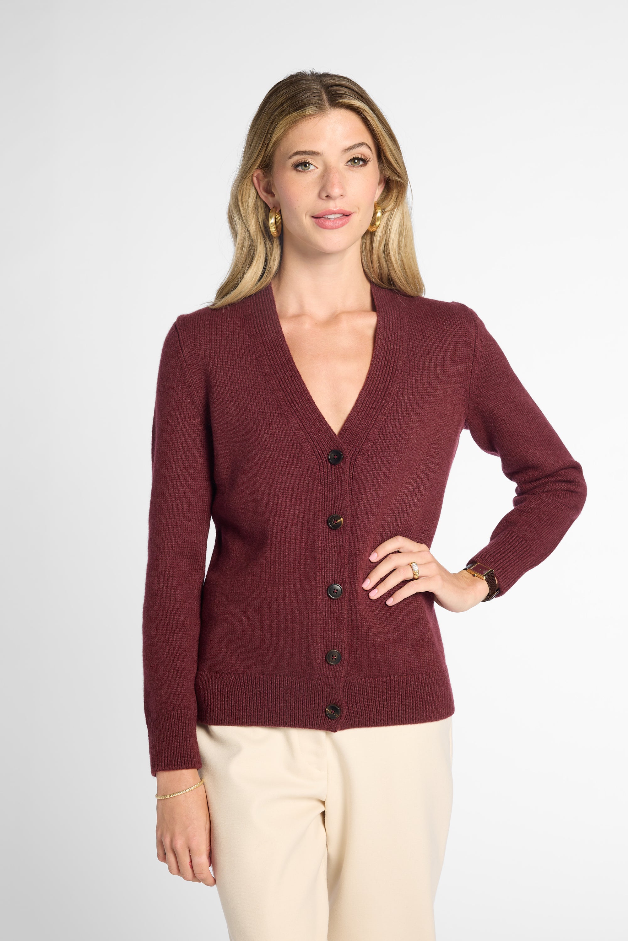 Front view of woman in Wine button-up cardigan in front of neutral background.