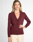 Front view of woman in Wine button-up cardigan in front of neutral background.