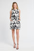 Woman wearing a sleeveless top and mini skirt a floral pattern on a white backdrop