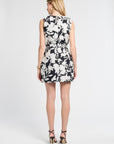 Lady wearing a black and white floral skirt and dress on a white background
