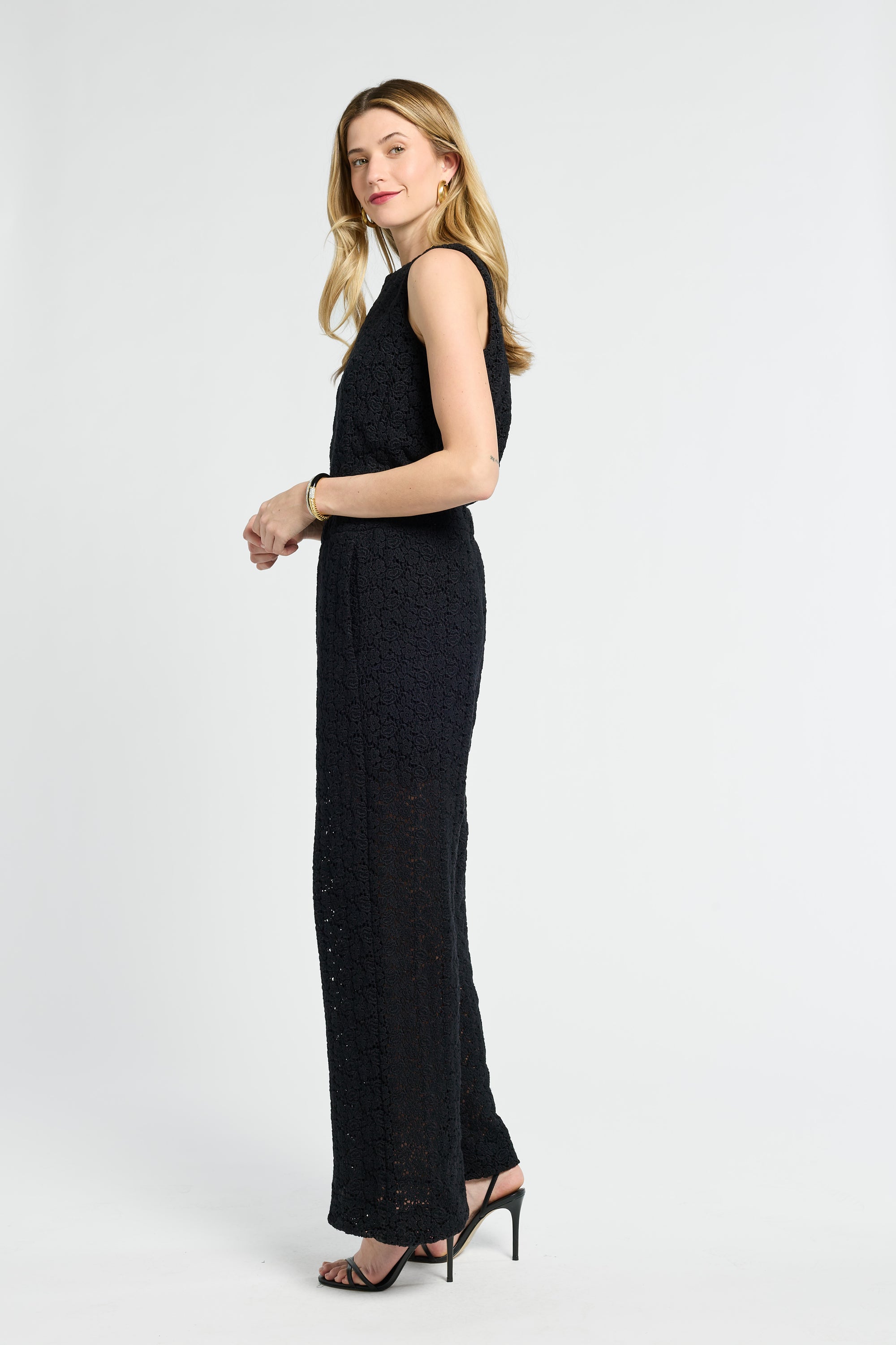 Woman wearing a black lace pants on a white background