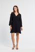 Woman wearing a mini black dress on a white background