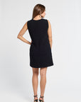 Woman wearing a black mini dress on a white background