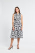 Woman wearing a black and white midi floral dress on a white background