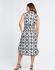 Woman dressed in a black and white floral dress on a white background