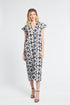 Woman wearing a black and white floral caftan on a white background