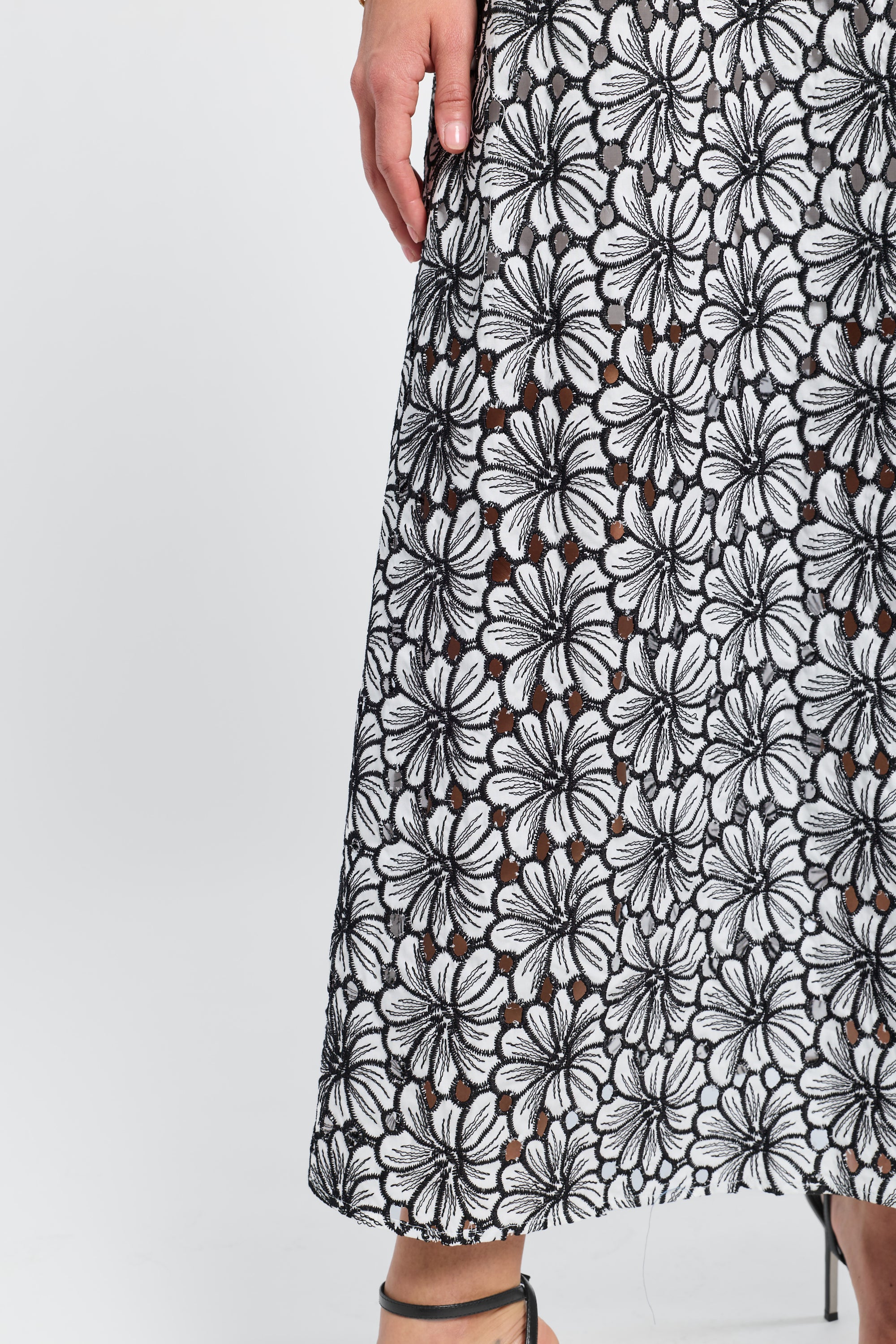 Black and white embroidered floral patterned caftan on a white background