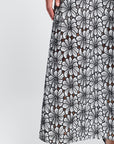 Black and white embroidered floral patterned caftan on a white background