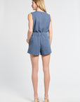 Woman wearing a pair of blue floral shorts on a white background