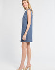 Woman modeling a floral blue dress on a white background