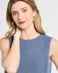 Woman wearing a blue patterned dress against a white background