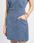 Blue patterned mini skirt worn by a person on a white background
