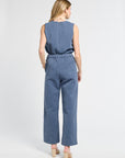 Woman wearing a pair of floral blue pants on a white background