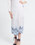 White outfit with a blue patterned white skirt on a plain background