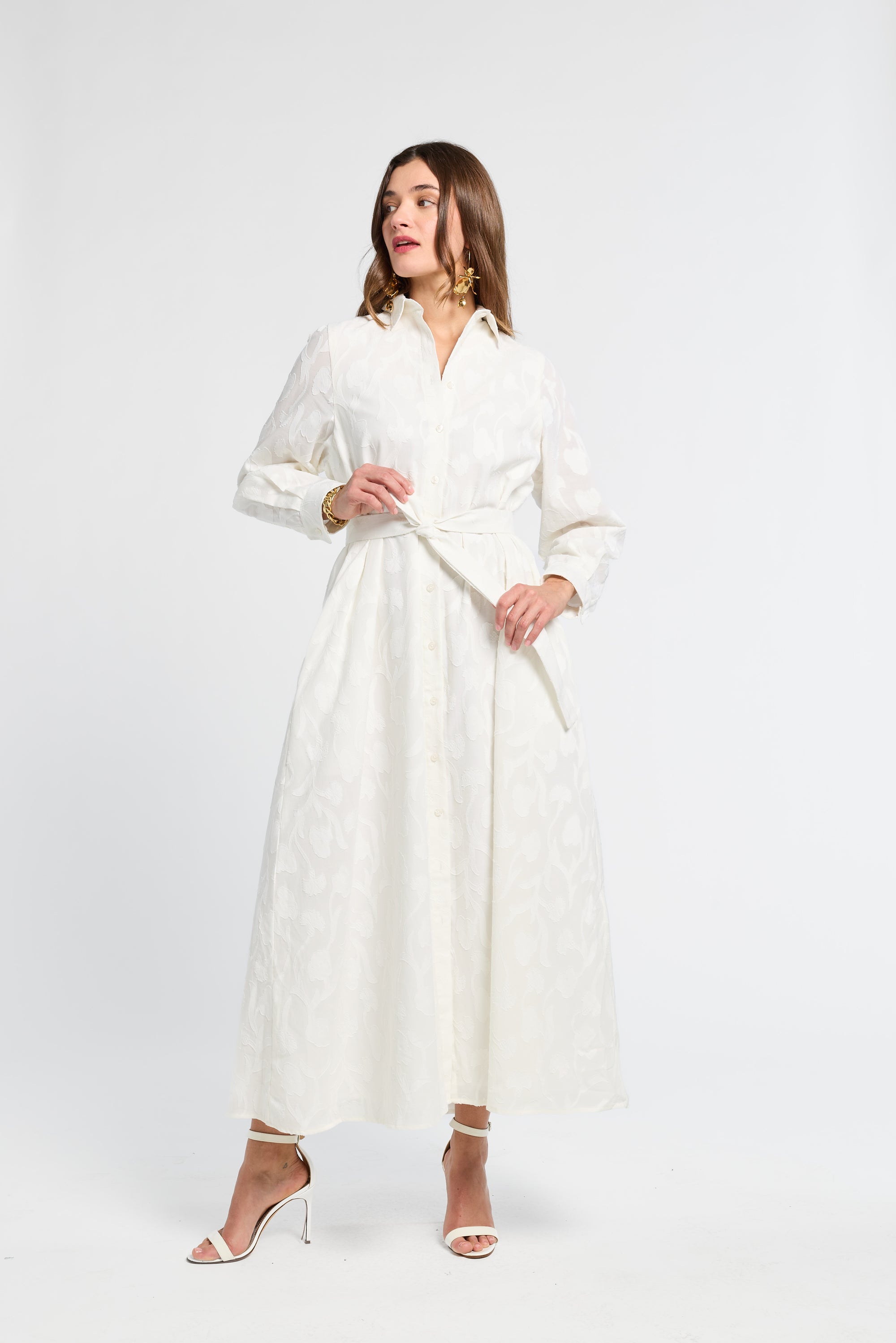 Woman wearing a white long sleeve dress on a white background