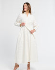 Woman wearing a white long sleeve dress on a white background