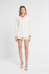 Woman wearing a white blouse and shorts on a white background