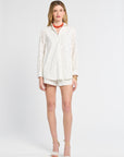 Woman wearing a white blouse and shorts on a white background