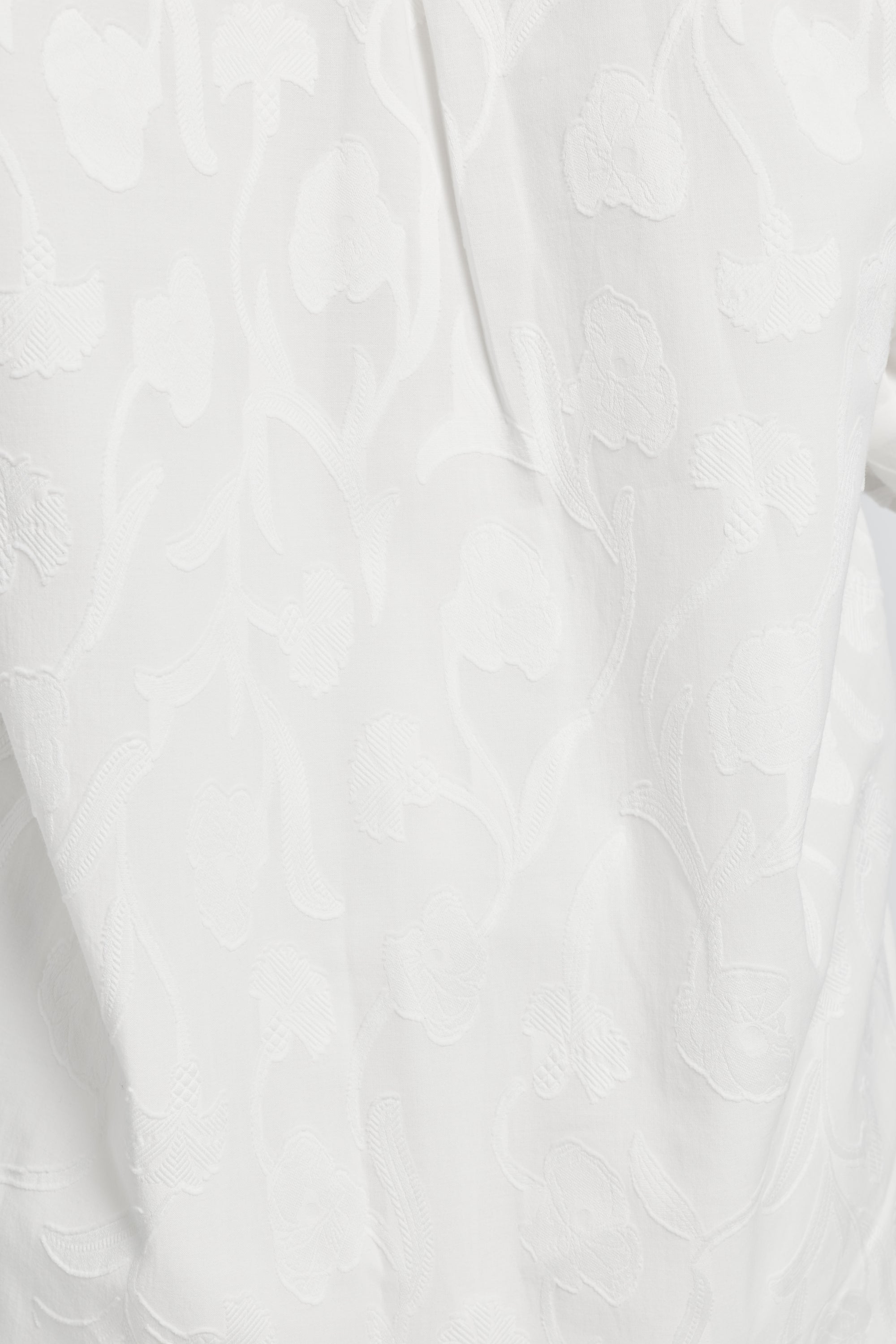 Close-up image of a white floral pattern on an article of clothing