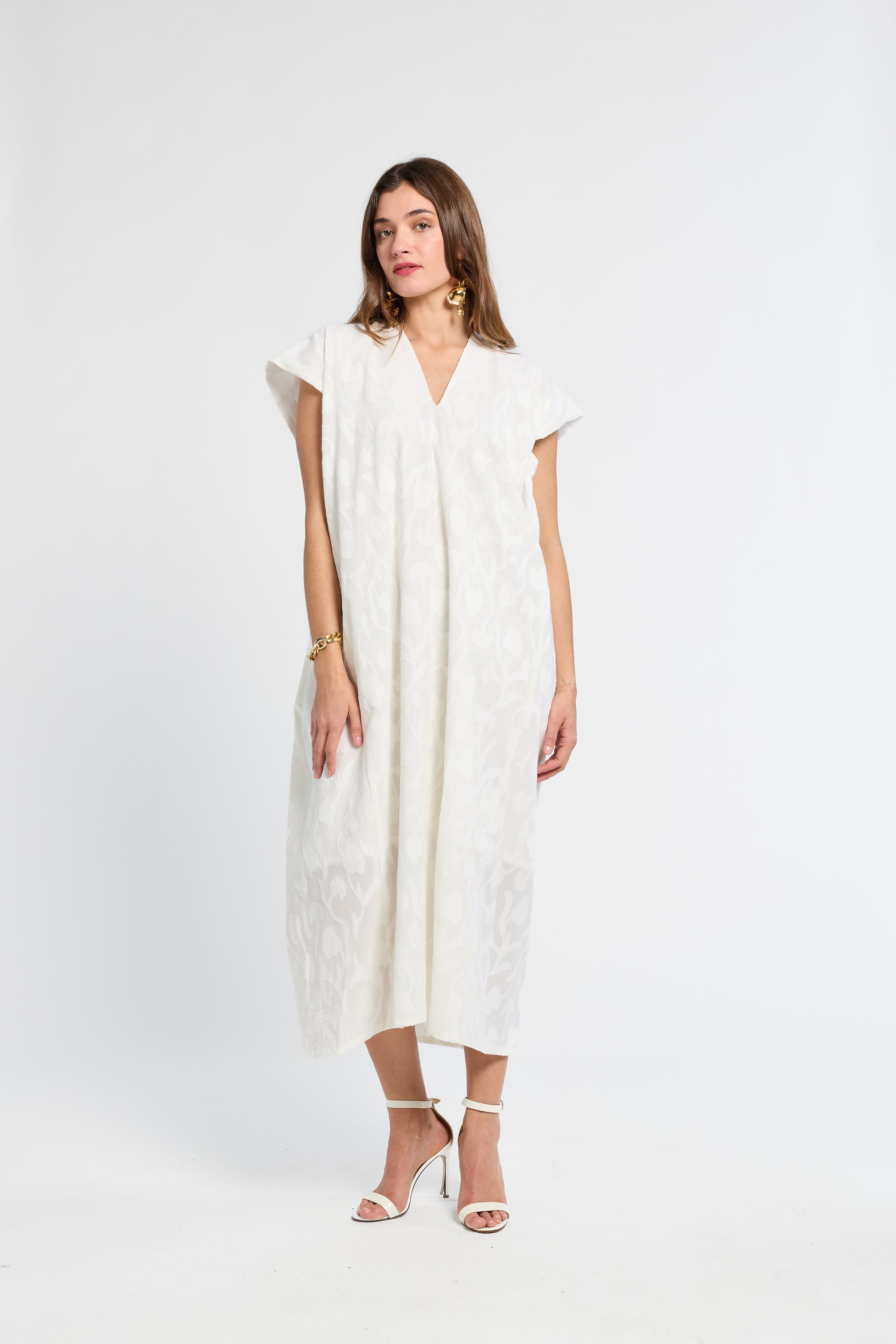 Woman wearing a white dress on a white background