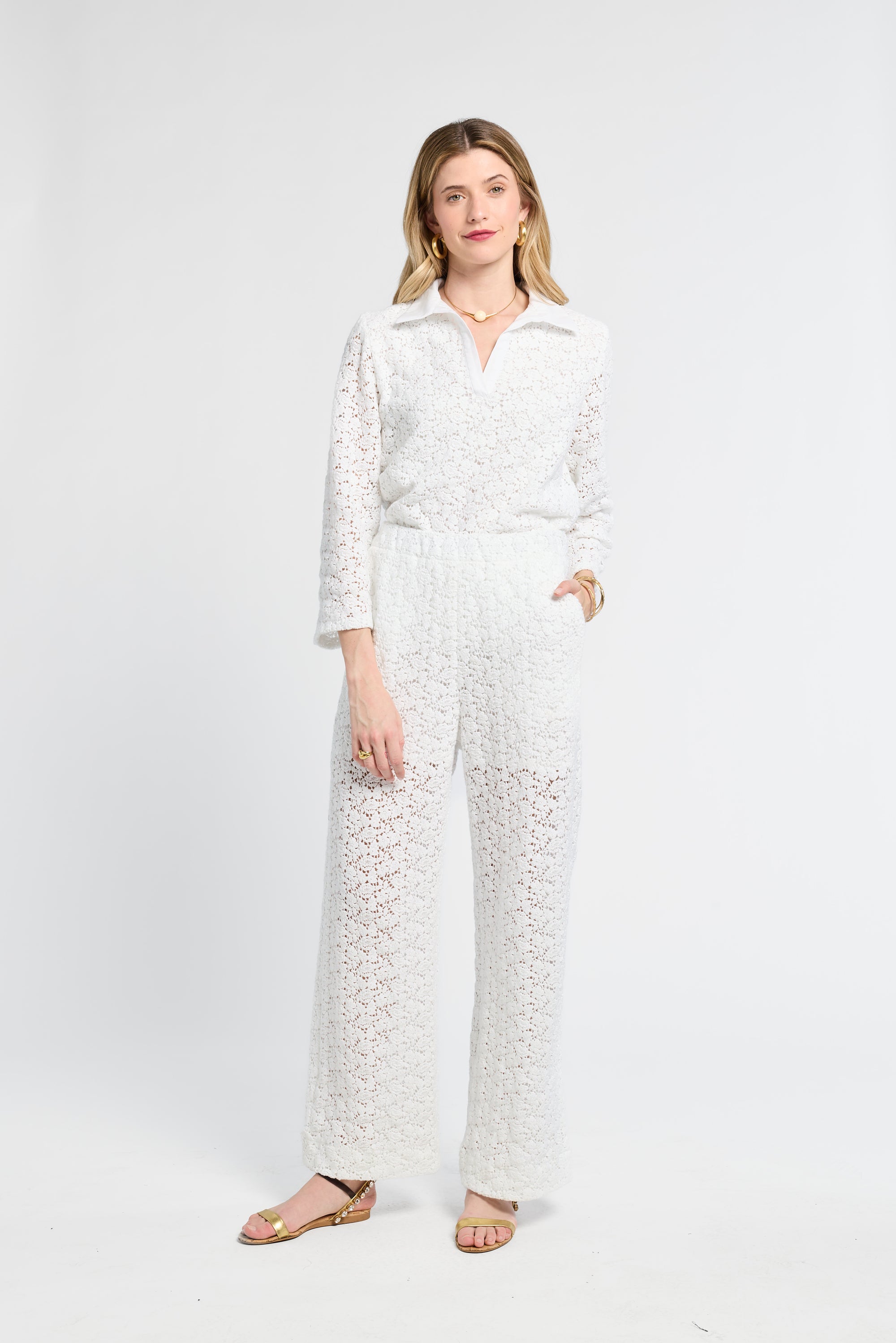 Woman wearing white lace pants on a white background