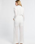 Woman wearing a white lace outfit on a white background