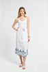 Woman wearing a white pareo with blue lace trim on a white background