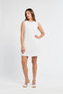 Woman wearing a white sleeveless lace dress on a white background