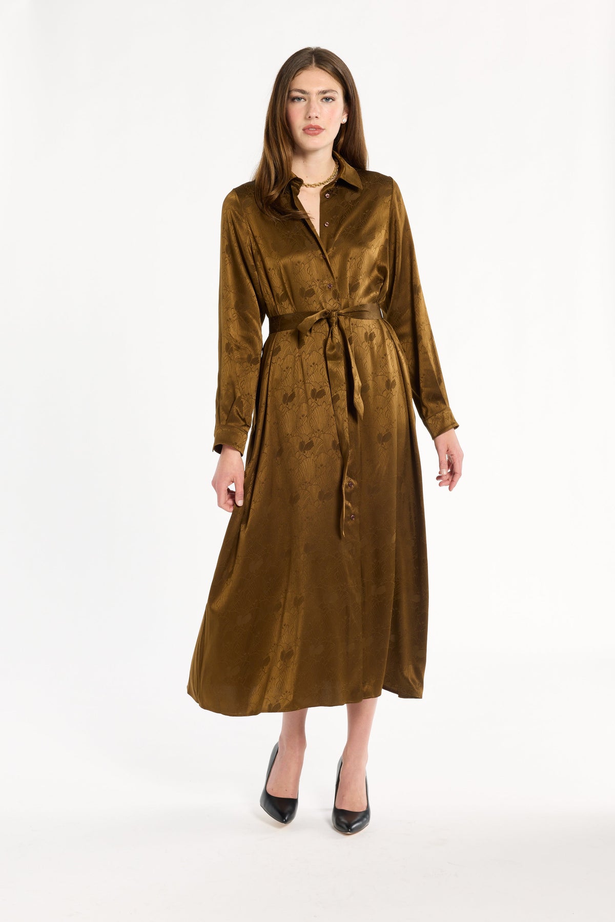 A woman modeling the Golden Umber Eleanor Shirt Dress belted at the waist with black heels, full-length front view, photographed against a plain white studio background.