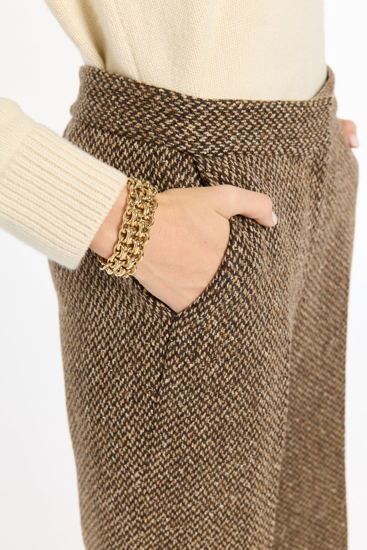 Close-up of the waistband, pocket, and brown woven texture of the Tobacco Tweed Ellis Pants, photographed against a plain white studio background.