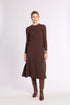 Woman wearing a brown ribbed knit skirt with brown boots on a white background