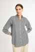 A woman modeling a striped button-up shirt in a vertical pattern, with the shirt collar visible and buttons done up to the top.