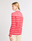 Woman wearing a pink striped sweater on a white background