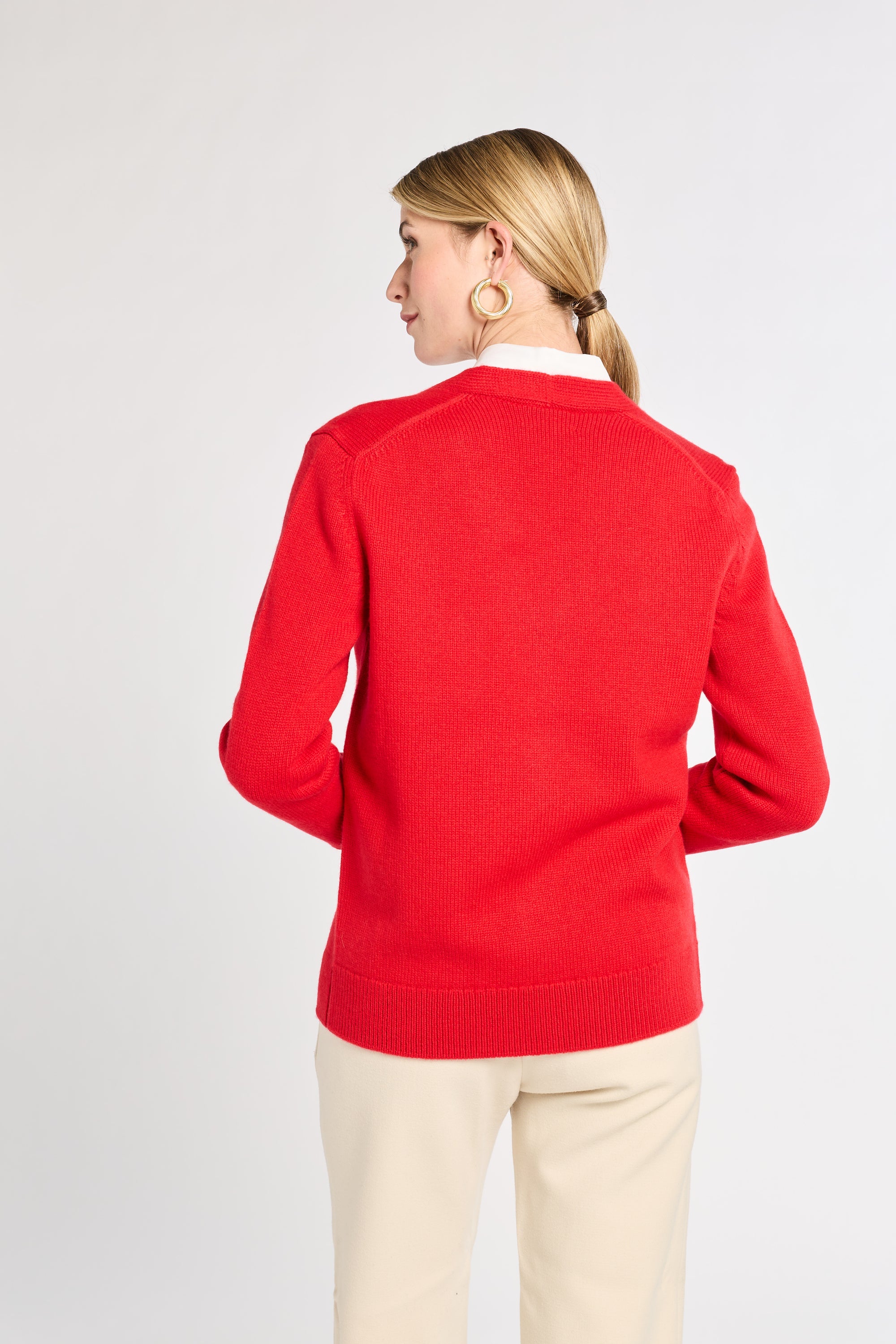 Woman wearing a red sweater on a white background