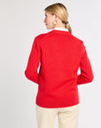 Woman wearing a red sweater on a white background