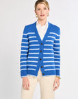 Woman wearing a blue and white striped cardigan on a light gray background